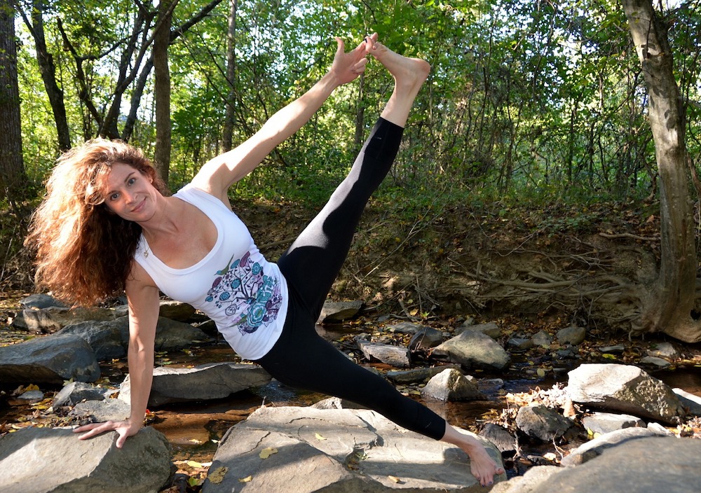 Woman in a natural setting performing a yoga pose