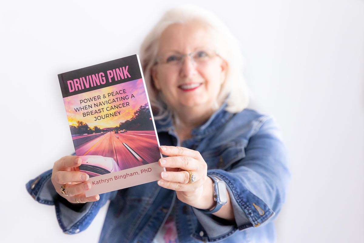 Dr. Kathryn Bingham holding her book, Driving Pink