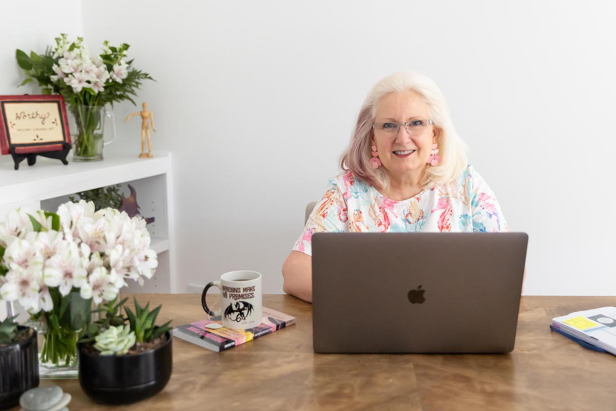 Dr. Kathryn Bingham at a desk using her laptop