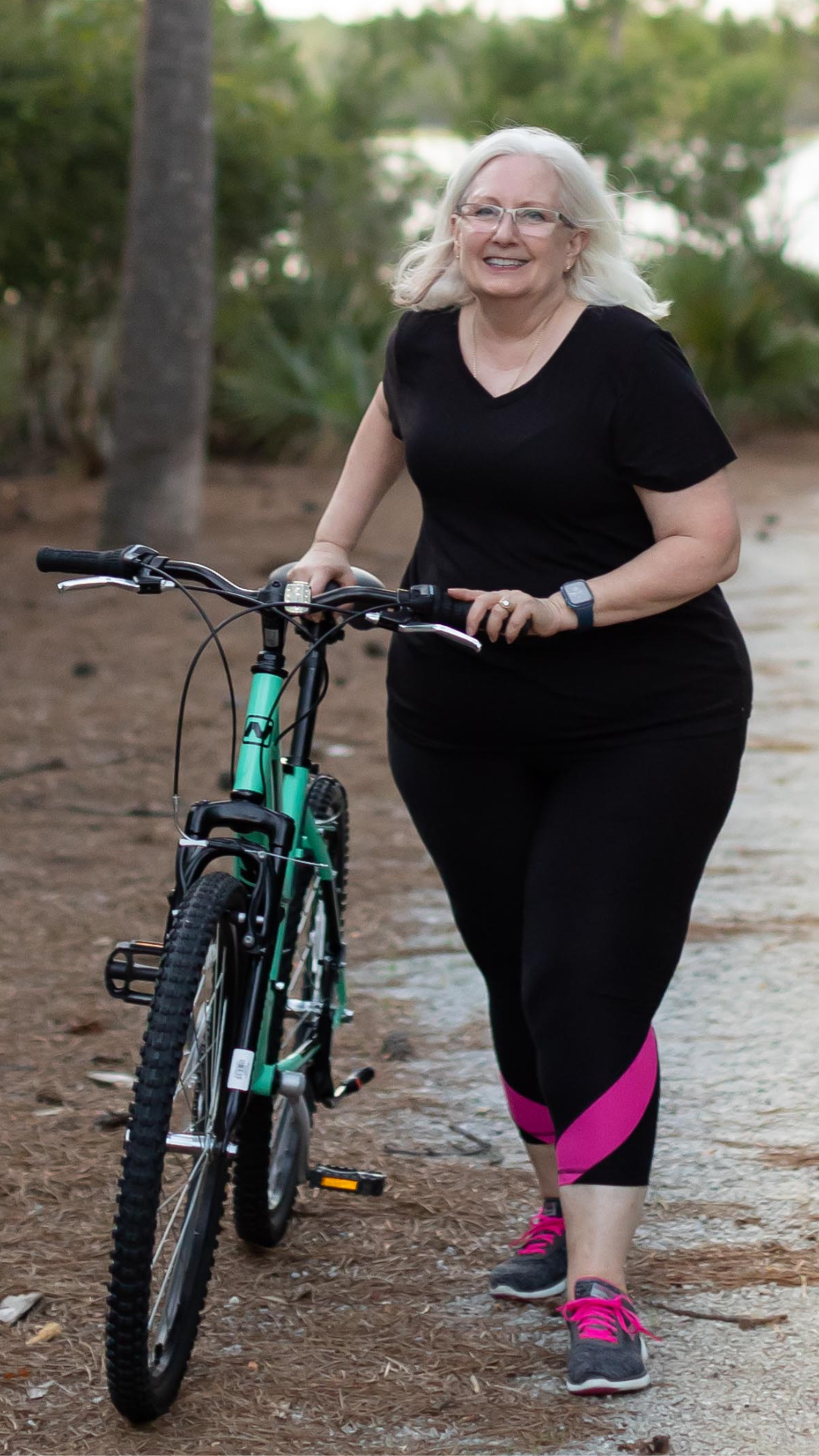 Dr Kathryn Bingham with bike on a path